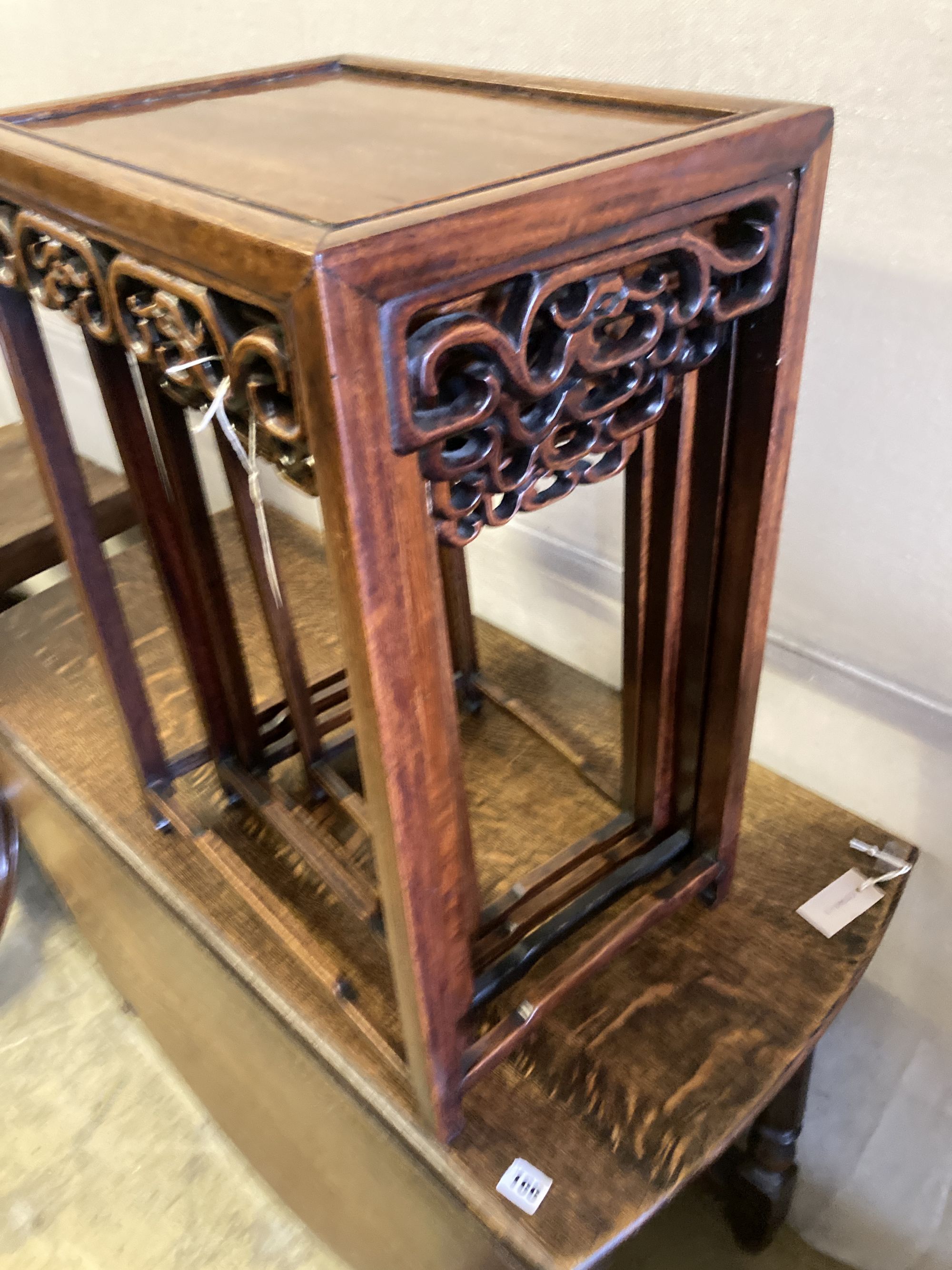 A nest of four Chinese carved hardwood tea tables, width 44cm, depth 33cm, height 62cm